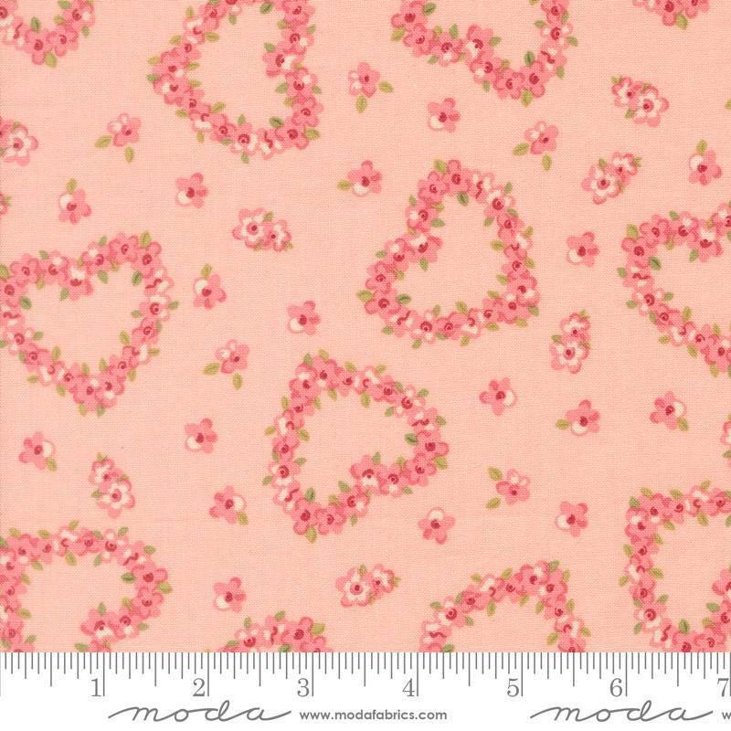 Image of Je Taime Flower Heart Blush quilting cotton fabric by Stacy Iest Hsu for Moda Fabrics. Features flowers on a pink background. Cute Little Fabric Shop.