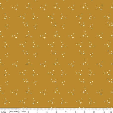 Image of Petals & Hazel Scatter Butterscotch quilting cotton fabric by Simple Simon & Company for Riley Blake Designs. Features stars on a gold background. Cute Little Fabric Shop.
