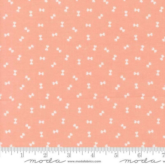 Image of Handmade Sweetness Confetti Peach quilting cotton fabric by My Sew Quilty Life for Moda Fabrics. Features bows on a pink background. Cute Little Fabric Shop.