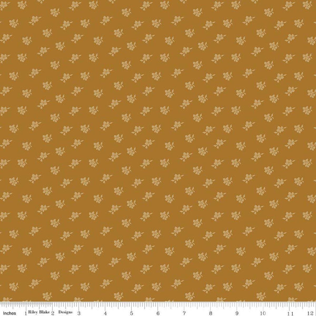 Image of Charmed & Treasured Magnolia Suede by Kassidy Grace for Riley Blake Designs. Features flowers on a gold background. Cute Little Fabric Shop.