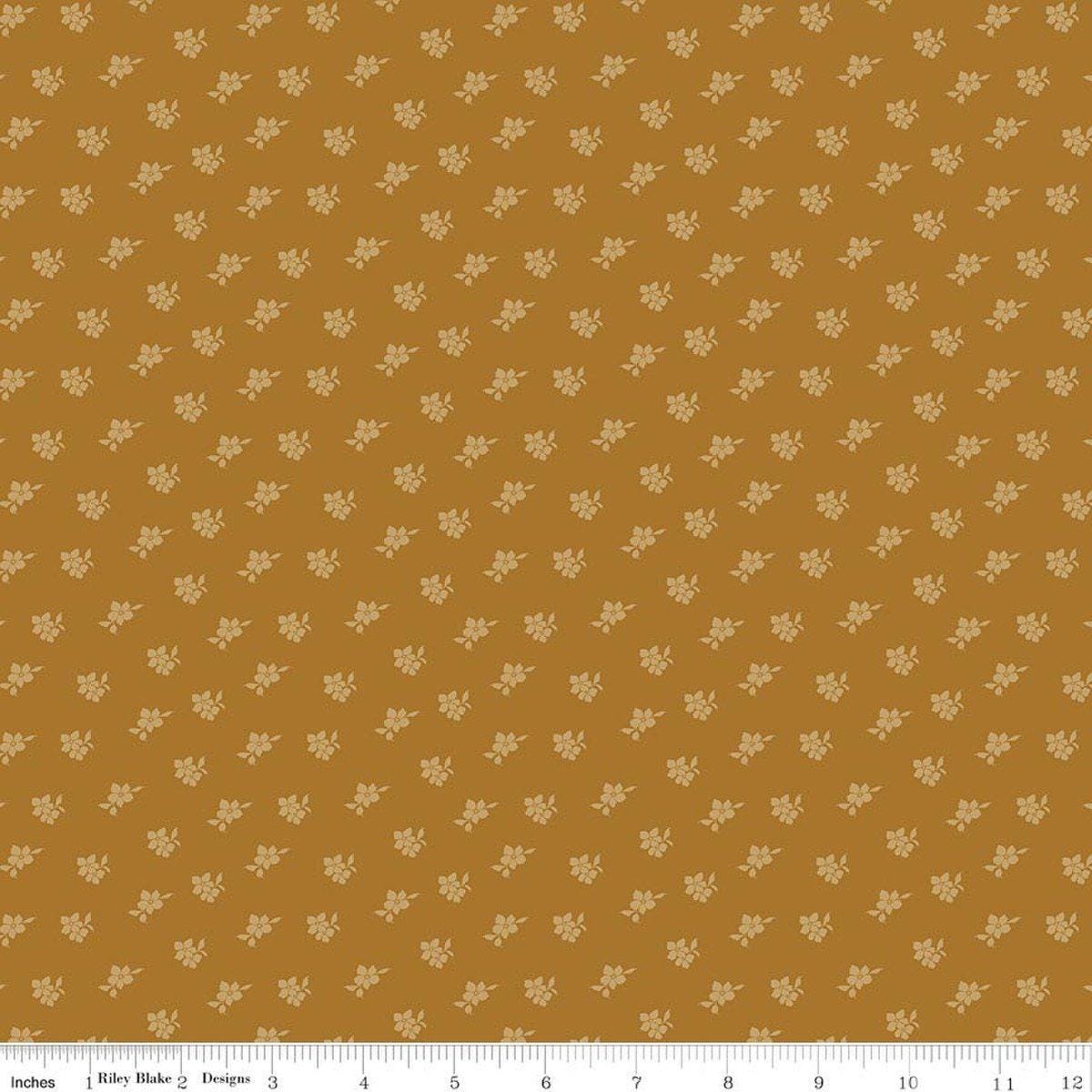 Image of Charmed & Treasured Magnolia Suede by Kassidy Grace for Riley Blake Designs. Features flowers on a gold background. Cute Little Fabric Shop.