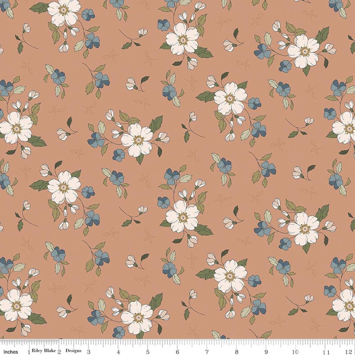 Image of Charmed & Treasured Main Light Clay by Kassidy Grace for Riley Blake Designs. Features flowers on a brown background. Cute Little Fabric Shop.