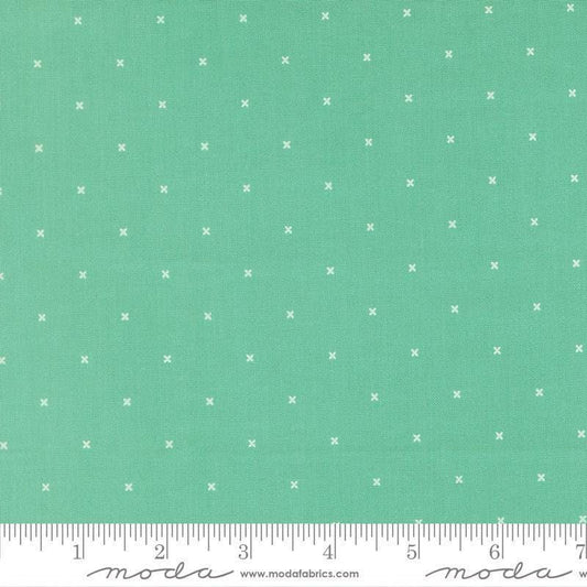 Image of Joysome Tiny Peel Peacock quilting cotton fabric by Corey Yoder for Moda Fabrics. Features tiny xs on a green blue background. Cute Little Fabric Shop.